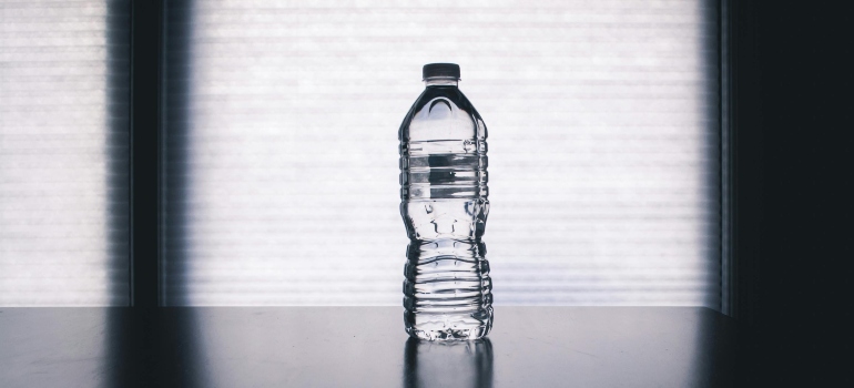 Clear Disposable Bottle on Black Surface